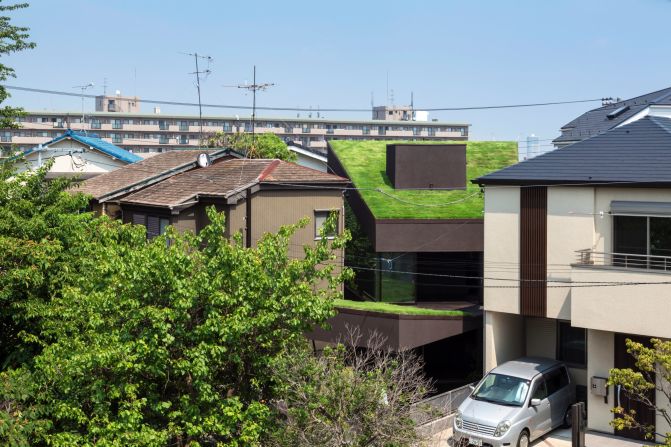The Grass Cave House by Tokyo-based Makiko Tsukada Architects is a wooden structure, featuring "hat-like" roofs that absorb solar radiation in summer, and function as insulation in the winter.