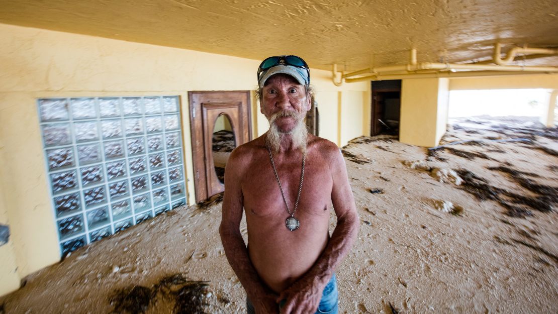 William "Dub" Richardson, caretaker of Seapointe condos, stands on three feet of sand that washed in.