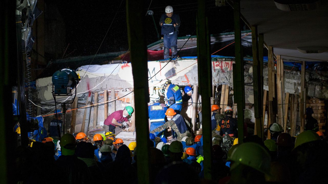 Hundreds of rescue workers work to find three people trapped inside the collapsed Enrique Rebsamen school in Mexico City on Wednesday night. Kara Fox/CNN