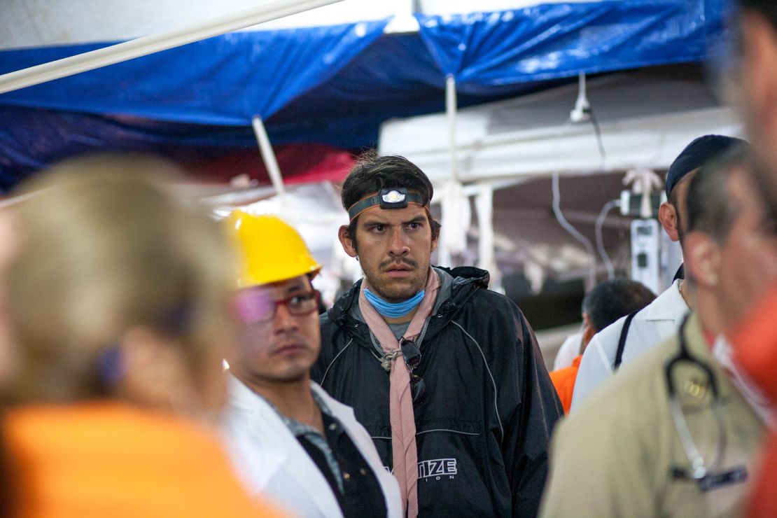 Inside the medical tent on the school site, volunteer doctors are briefed on the progress of the rescue effort. 