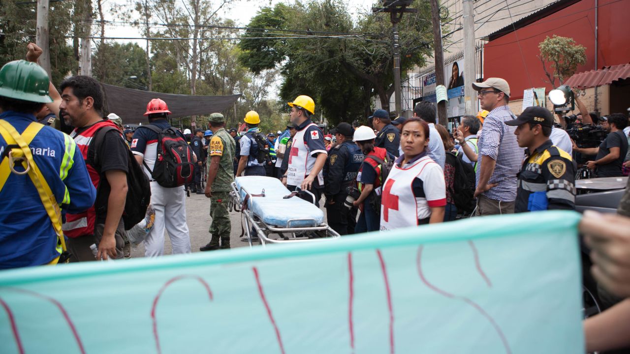 Medics from the Mexican Red Cross stand by with a stretcher.