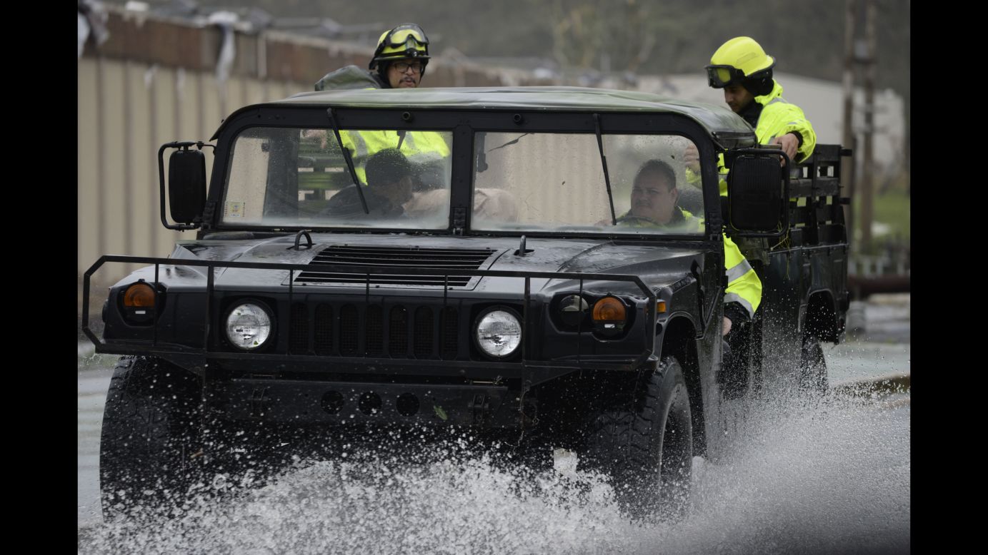 Rescue workers drive through a flooded road in Humacao, Puerto Rico, on Wednesday, September 20.