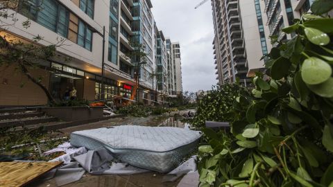 A mattress that fell from the third floor is surrounded by debris outside a San Juan apartment complex on September 20.