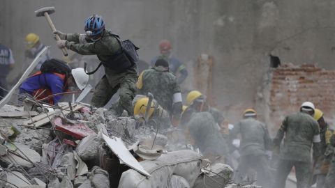 Rescue workers search for survivors Thursday, September 21, at a collapsed apartment building in Mexico City. 
