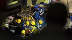 Search and rescue team members work to bring down a large piece of concrete during rescue efforts at the Enrique Rebsamen school in Mexico City, Mexico, Thursday, Sept. 21, 2017. A delicate effort to reach a young girl buried in the rubble of the school stretched into a new day on Thursday, a vigil broadcast across the nation as rescue workers struggled in rain and darkness to pick away unstable debris and reach her.  (AP Photo/Anthony Vazquez)