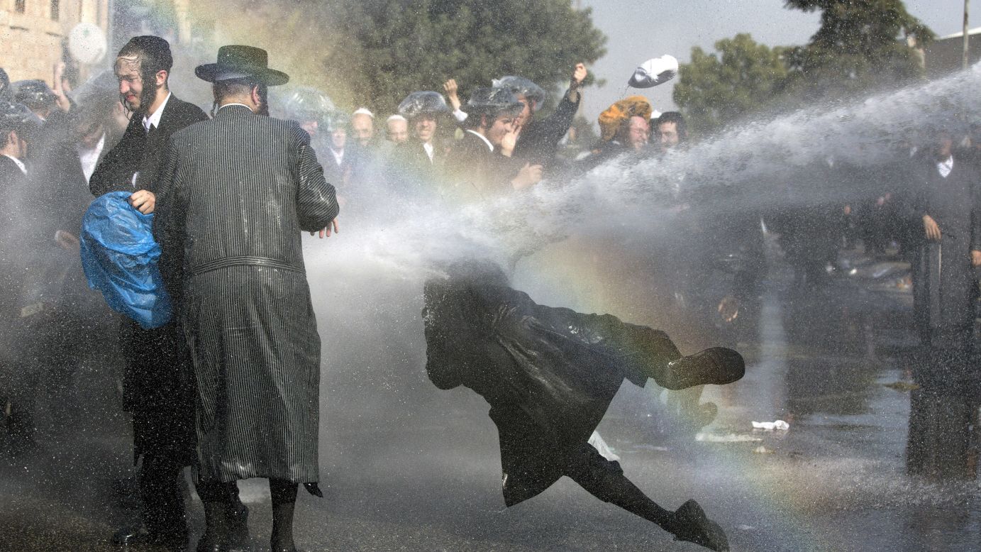 Israeli police use a water cannon to disperse ultra-Orthodox Jews who were holding an anti-draft protest on Sunday, September 17. Earlier this month, the Israeli Supreme Court rejected a bill that would have exempted some ultra-Orthodox Jews from mandatory military service.