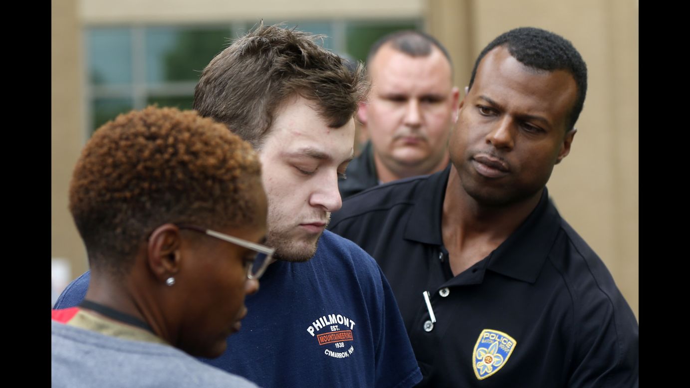 Kenneth James Gleason is escorted by police to a waiting police car in Baton Rouge, Louisiana, on Tuesday, September 19. Gleason, 23, <a href="http://www.cnn.com/2017/09/19/us/baton-rouge-shootings/index.html" target="_blank">was charged with murder </a>after police matched his DNA to shell casings found at the scene of a pair of homicides, authorities said.