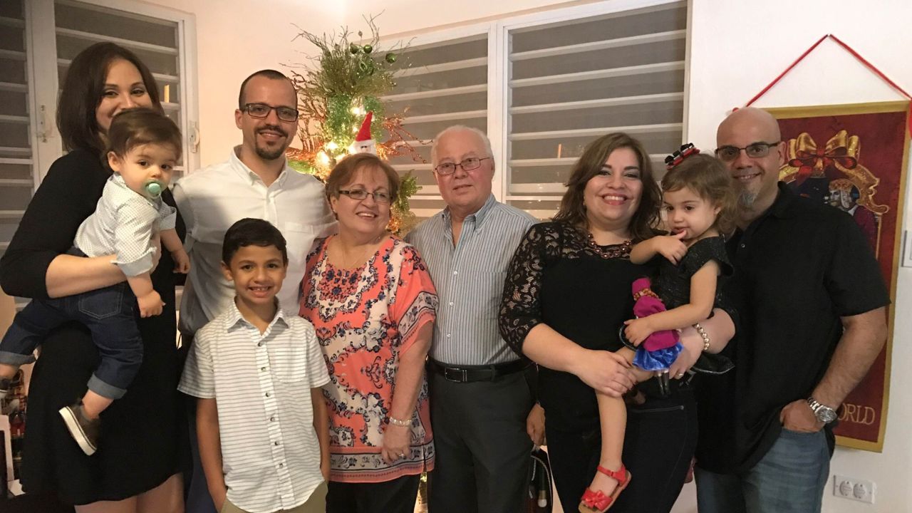 Gretchen Lopez' family in Puerto Rico. From left to right: sister-in-law Cristine Arana (Joaquin Flores, nephew in her arms), brother Ruben Flores Agrait (his son Esteban Flores in front of him), mom Wilma Agrait, dad Ruben Flores, Gretchen Lopez, husband and daughter Alana.