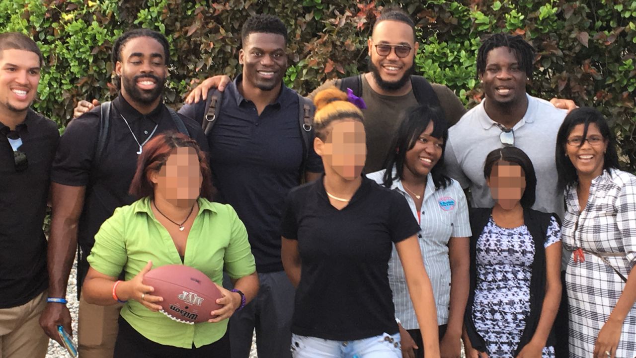 NFL players and women of Lily House, a rehabilitation facility for victims of sex trafficking. CNN has blurred some of the faces in this photo in order to respect their privacy.