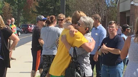 People embrace outside Mattoon High School after the shooting on Sept. 20, 2017.