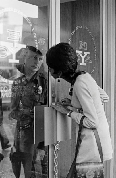 A woman locked out of the Economic and Youth Opportunities Agency in Los Angeles, c. 1973.