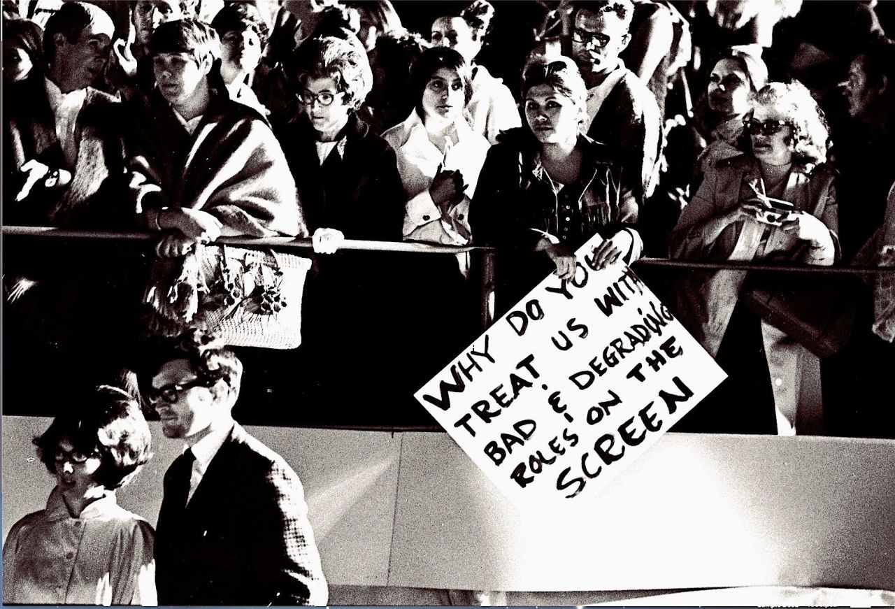 Picketers and adoring crowds surround the red carpet at the 1970 Academy Awards in Los Angeles. 