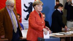 German Chancellor Angela Merkel casts her vote at a polling station in Berlin during general elections on September 24.