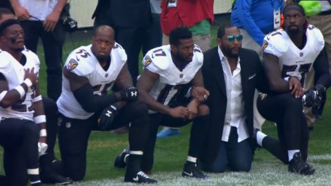 No. 55 Terrell Suggs and Ray Lewis, in suit, were among the Ravens kneeling Sunday. 