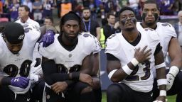 Baltimore Ravens players kneel down during the playing of the U.S. national anthem before an NFL football game against the Jacksonville Jaguars at Wembley Stadium in London, Sunday Sept. 24, 2017.
