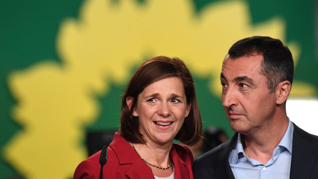 Katrin Göring-Eckardt (L) and Cem Özdemir of the Green party speak to supporters after exit poll results were announced on Sunday. 