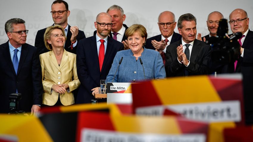 German Chancellor and Christian Democrat (CDU) Angela Merkel (C) reacts to initial results that give the party 32,9% of the vote, giving it a first place finish, in German federal elections on September 24, 2017 in Berlin, Germany. Chancellor Merkel is seeking a fourth term and coming weeks will likely be dominated by negotiations between parties over the next coalition government. 