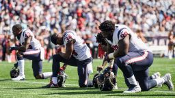 FOXBORO, MASSACHUSETTS - SEPTEMBER 24:  Members of the Houston Texans kneel before a game against the New England Patriots at Gillette Stadium on September 24, 2017 in Foxboro, Massachusetts.  (Photo by Billie Weiss/Getty Images)