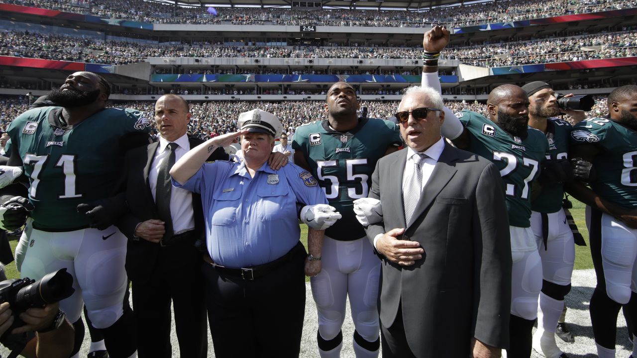 Philadelphia Eagles owner Jeff Lurie joins his players for the national anthem. 