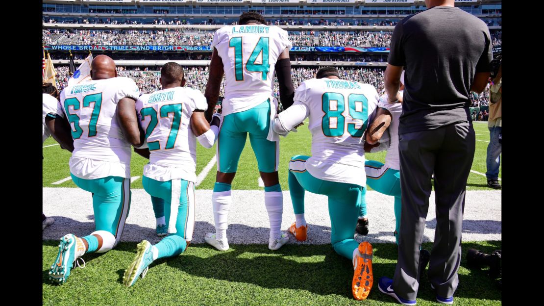 EAST RUTHERFORD, NJ - SEPTEMBER 24: Laremy Tunsil #67, Maurice Smith #27 and Julius Thomas #89 kneel with Jarvis Landry #14 of the Miami Dolphins during the National Anthem prior to an NFL game against the New York Jets at MetLife Stadium on September 24, 2017 in East Rutherford, New Jersey.  (Photo by Steven Ryan/Getty Images)