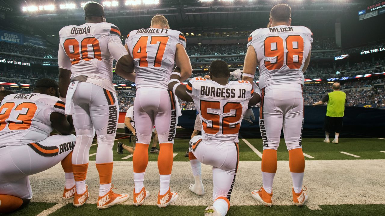 Cleveland Browns players take a knee and join arms during a game against the Indianapolis Colts.