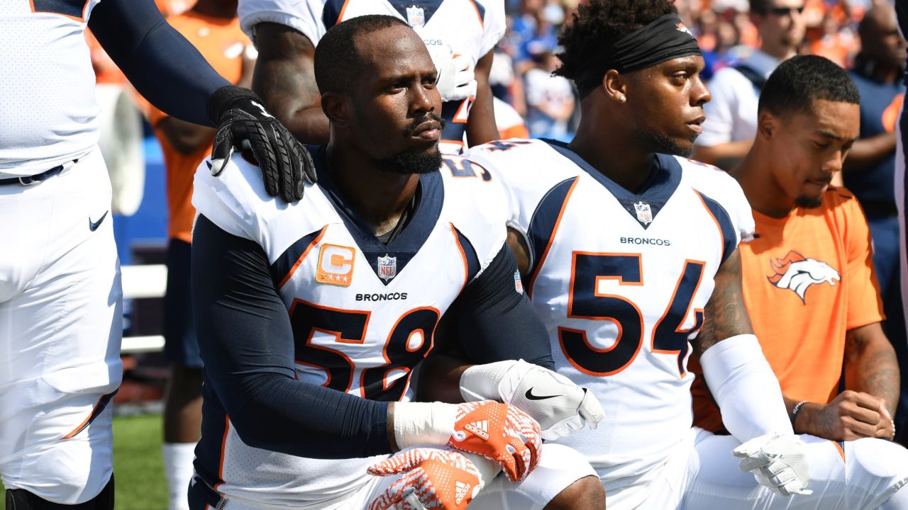 Denver Broncos Von Miller, left, and Brandon Marshall  take a knee during the anthem before their game.