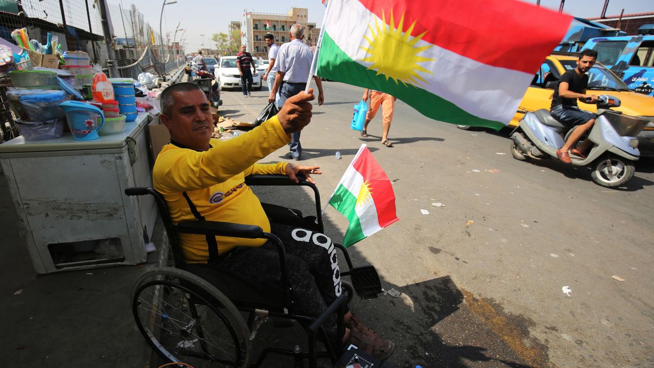 A man waves a Kurdish flag in central Kirkuk on the eve of the independence referendum.