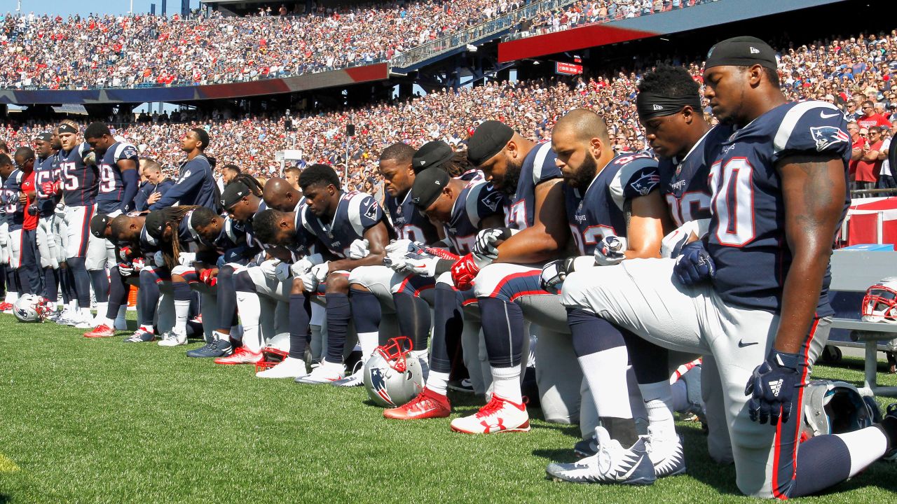Members of the New England Patriots kneel during the national anthem before an NFL game on September 24, 2017. 
