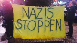 Large banner outside AFD election party rally reading "stop Nazis"