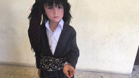 Six-year old Hedad holds three rocks, each representing "divorce" from Iraq.