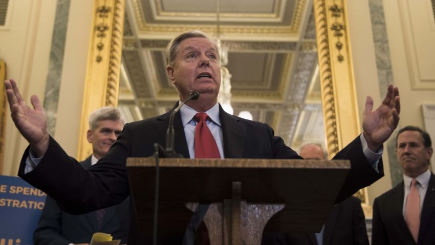 Senator Lindsey Graham (C), R-SC, stands with Senator Bill Cassidy, R-LA, Senator Dean Heller (L), and Senator Ron Johnson, R-WI, as well as former Senator Rick Santorum (R), to announce their legislation to repeal and replace Obamacare through block grants on Capitol Hill in Washington, DC, on September 13, 2017.   / AFP PHOTO / JIM WATSON        (Photo credit should read JIM WATSON/AFP/Getty Images)