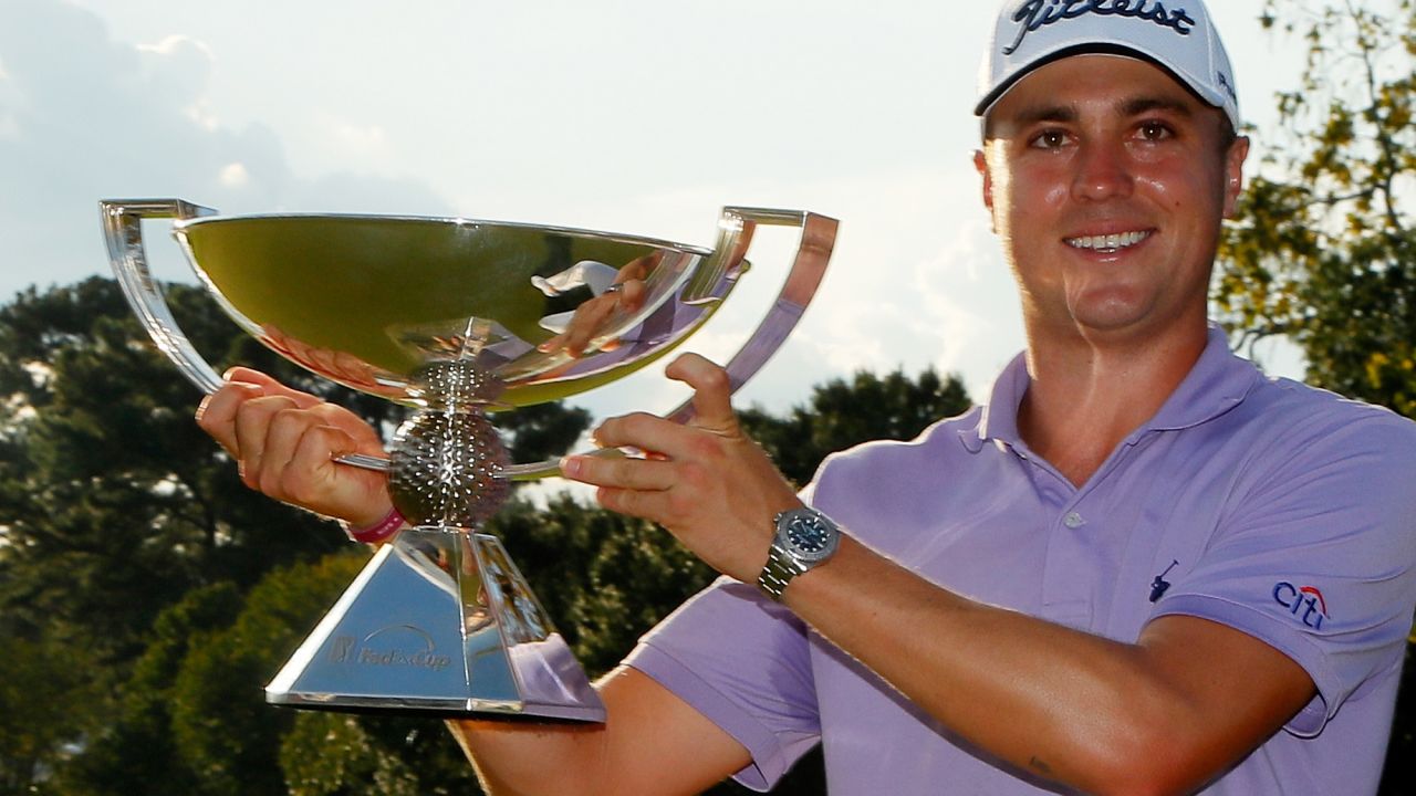 ATLANTA, GA - SEPTEMBER 24:  Justin Thomas of the United States celebrates with the trophy on the 18th green after winning the FedExCup and second in the TOUR Championship during the final round at East Lake Golf Club on September 24, 2017 in Atlanta, Georgia.  (Photo by Kevin C. Cox/Getty Images)