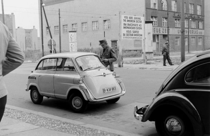 <strong>Friedrichstrasse, August 3, 1960</strong>: This photograph shows a guard questioning a driver on the border. "Before they built the wall, you could simply walk across, but afterwards you had to go through a control and change a certain minimum amount of currency at a ridiculous exchange rate," recalls Hailstone. "It was very different after 1961."