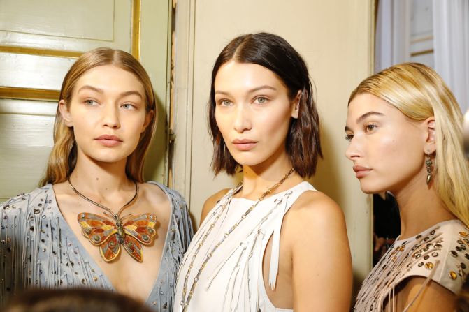 Gigi Hadid, Bella Hadid and Hailey Baldwin pose backstage at Bottega Veneta, where leather tassels were plentiful and the costume jewelery featured giant butterflies.