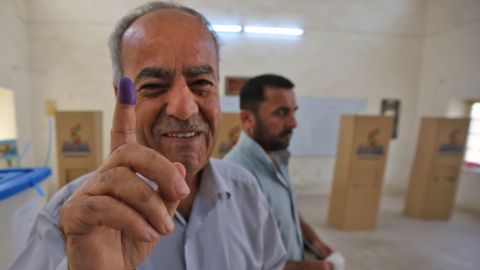 An Iraqi Kurdish man shows his ink-stained finger after voting in Kirkuk on Monday. 