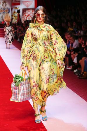 A model carries her weekly shopping down the Dolce & Gabbana catwalk. 