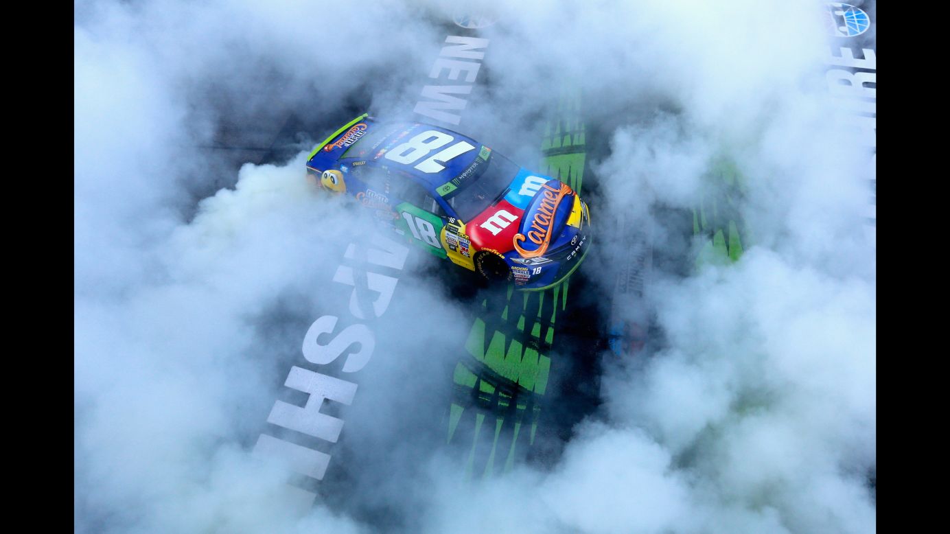 NASCAR driver Kyle Busch celebrates with a burnout after winning the Cup Series race in Loudon, New Hampshire, on Sunday, September 24. It was the second race of the playoffs.