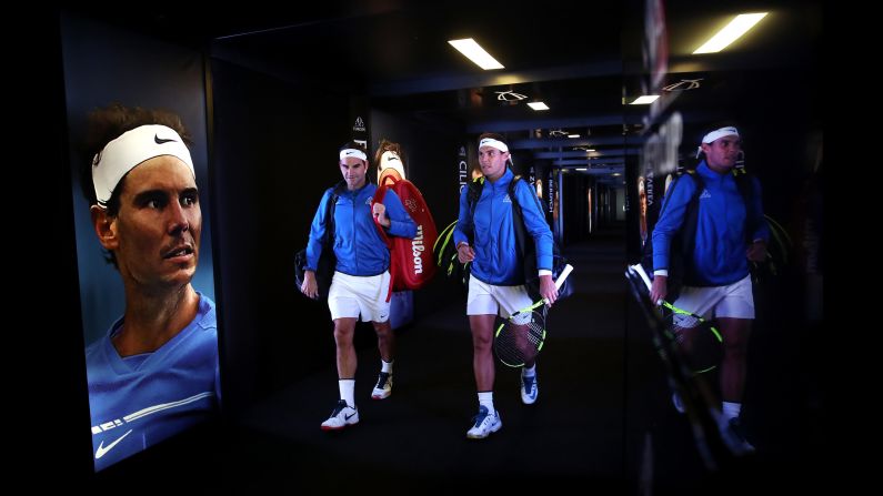 Longtime tennis rivals Roger Federer, left, and Rafael Nadal enter the arena to play a doubles match together in Prague, Czech Republic, on Saturday, September 23. They won their match for Team Europe, which went on to defeat Team World in the inaugural Laver Cup.