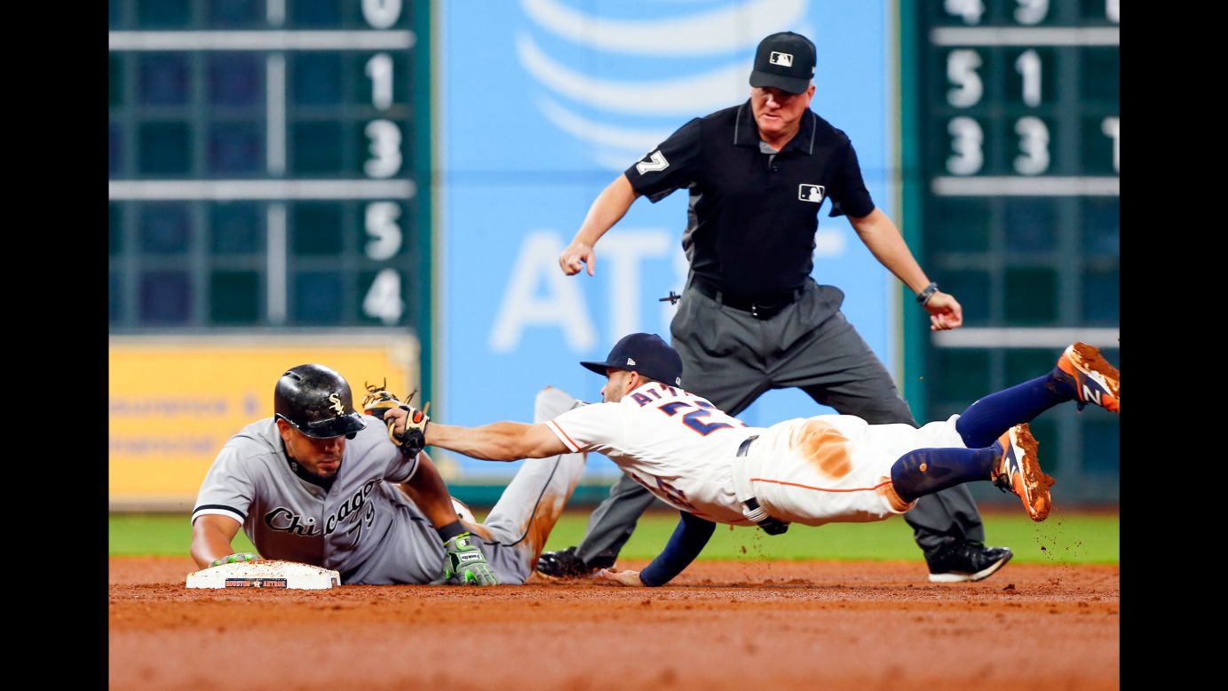 Jose Abreu, first baseman for the Chicago White Sox, avoids a tag from Houston's Jose Altuve on Thursday, September 21.