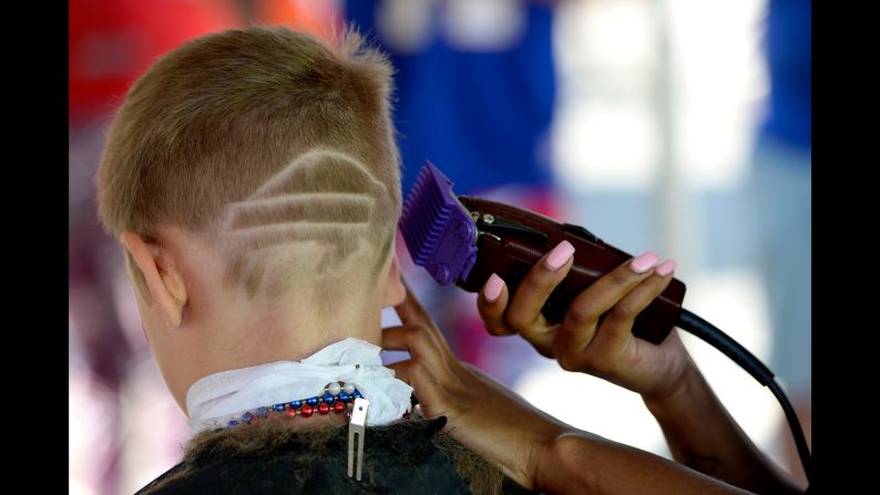 A Buffalo Bills fan has the team's logo shaved into his head before a game on Sunday, September 24.