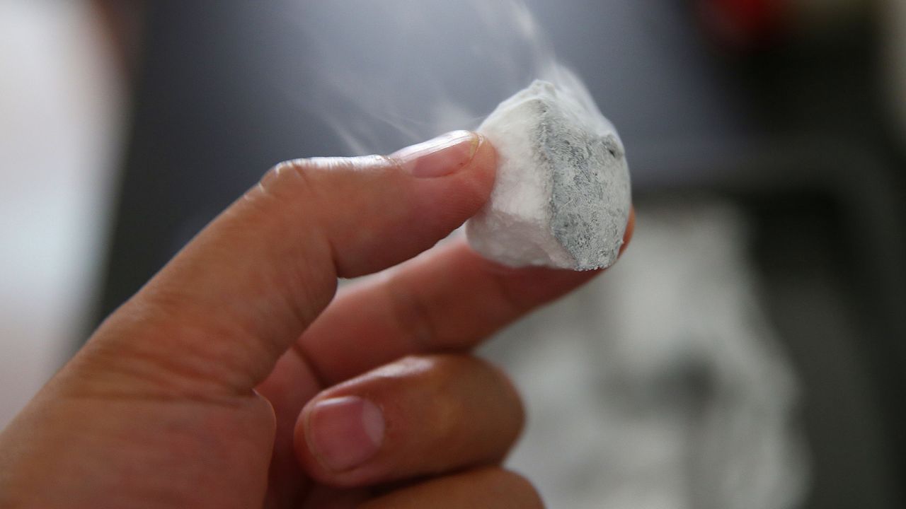 A scientist holds marine natural gas hydrate trapped in icelike crystals, extracted from the seabed of the Shenhu Area of the northern South China Sea. Similar marine natural gas hydrates have been extracted from Japan.