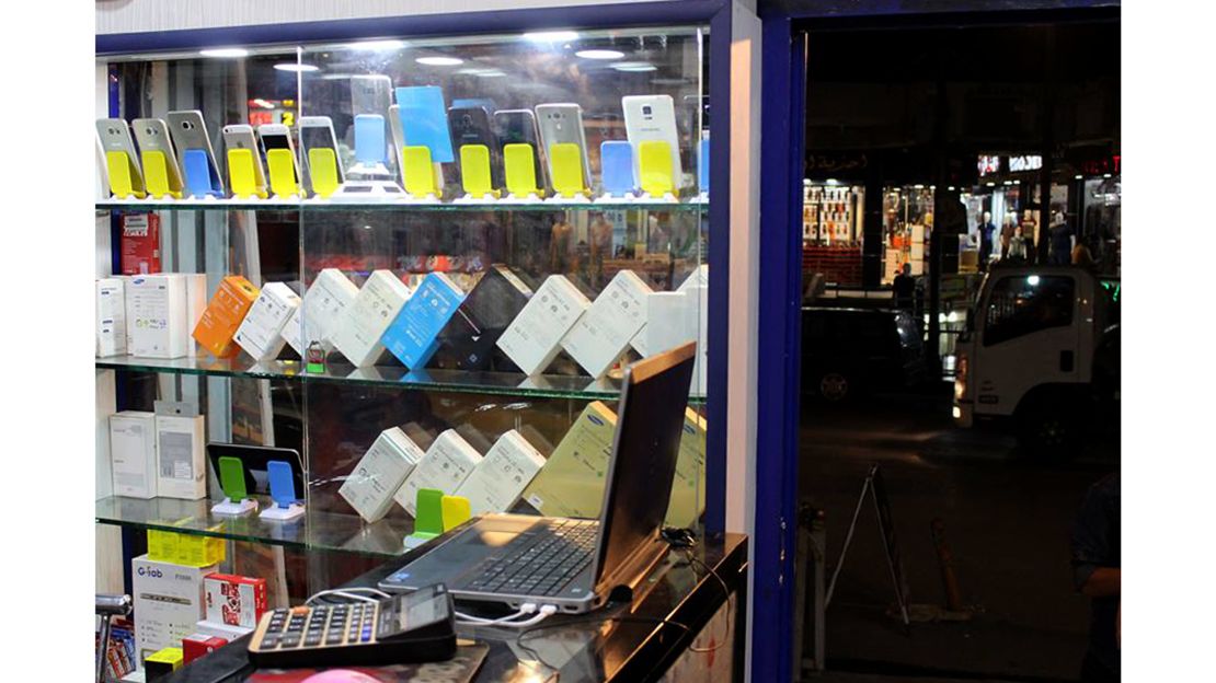 Smartphone cases can be seen in the window of an electronics shop in Mosul, Iraw.