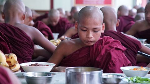 A novice monk eats lunch at ZayTaWon DammarYone Monastery, Mingalardone township near Yangon on Wednesday September 20.