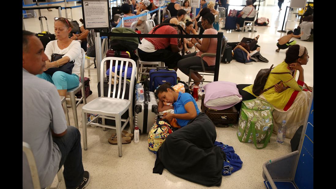 Yancy Leon rests at the Luis Muñoz Marin International Airport near San Juan on September 25. She's been waiting in line for two days to get a flight out.