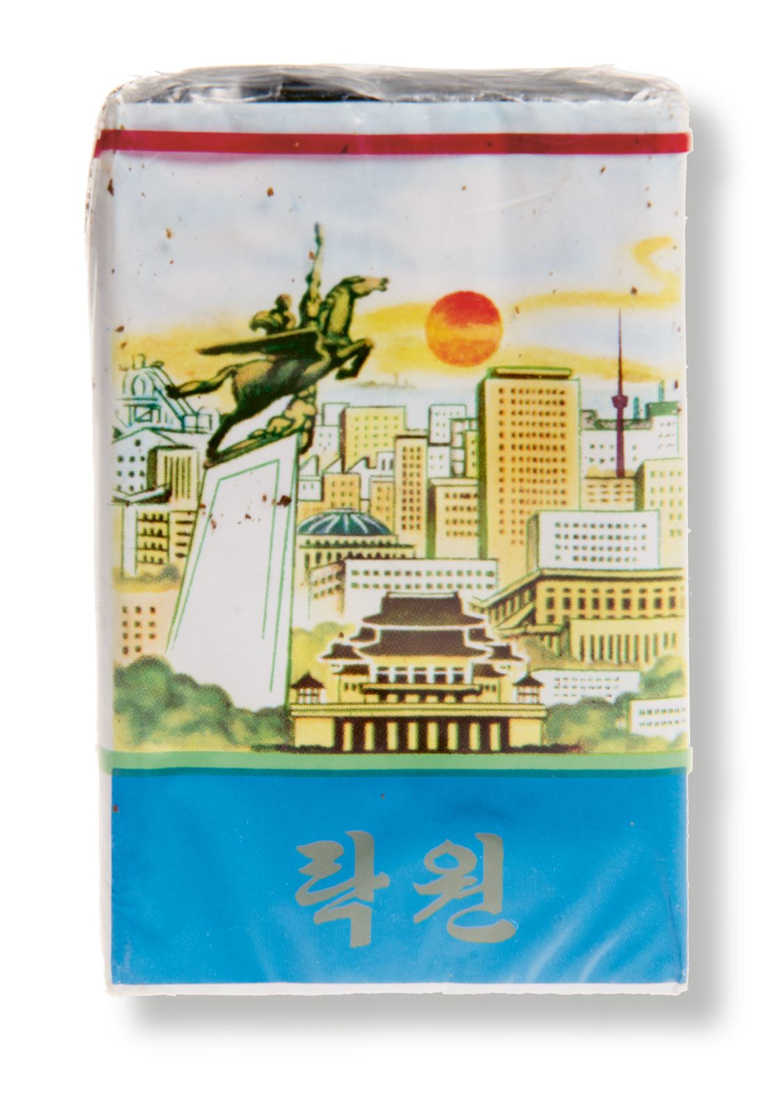 A packet of cigarettes by the Rakwon brand. It features images of Pyongyang structures including a statue of the Chollima: a mythical winged horse. 