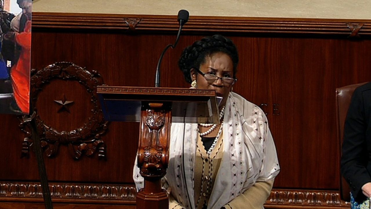 Congresswoman Sheila Jackson Lee kneeling in defense of the First Amendment.