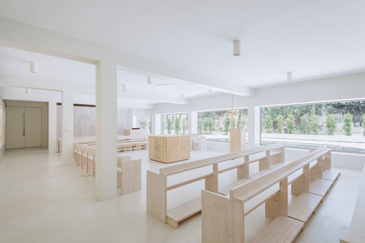 The interior was designed to create a simple place of worship and features simple wooden furniture and minimal decor. 