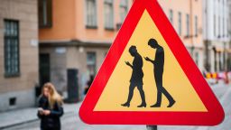 TOPSHOT - A road sign Warning Against pedestrians focusing on their smartphones is pictured on February 2, 2016 near the old town in Stockholm. / AFP / JONATHAN NACKSTRAND        (Photo credit should read JONATHAN NACKSTRAND/AFP/Getty Images)