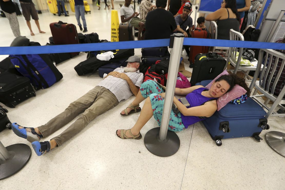 Stranded passengers rest Monday at San Juan's  Luis Muñoz Marín International Airport.