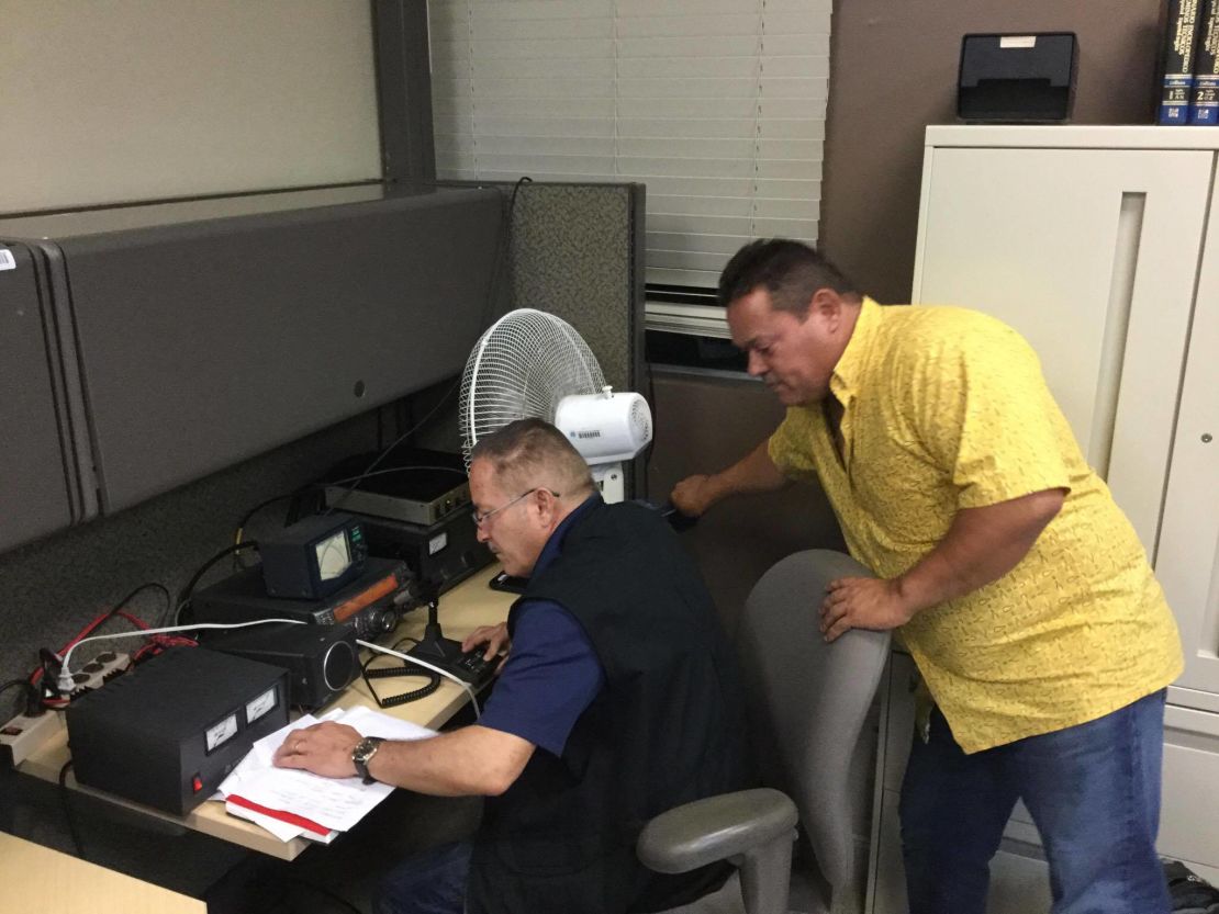 Raul Gonzalez and Jose Santiago work to maintain the communication infrastructure they set up between ham radio operators in the Monacillo Control Center.